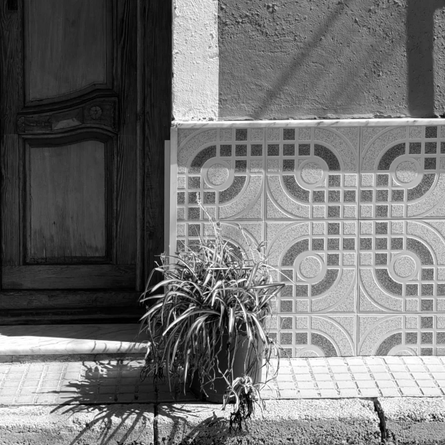 Doorway with decorative tiles in the narrow streets of Benigembla, in black and white