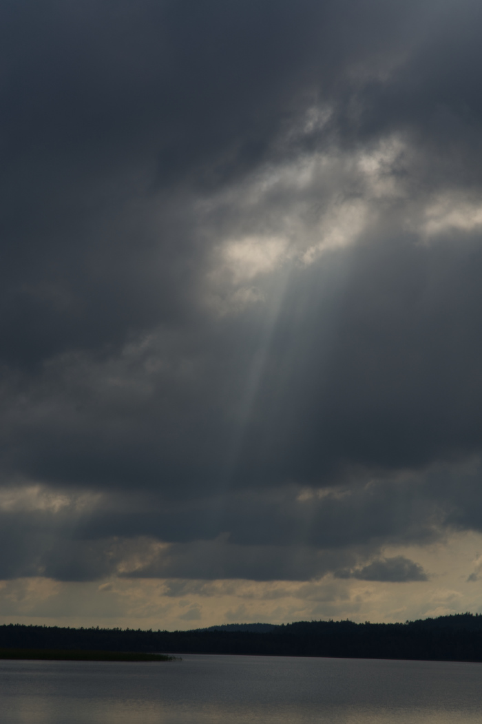 Dark clouds and a sunbeam above Flatens lake, Sweden