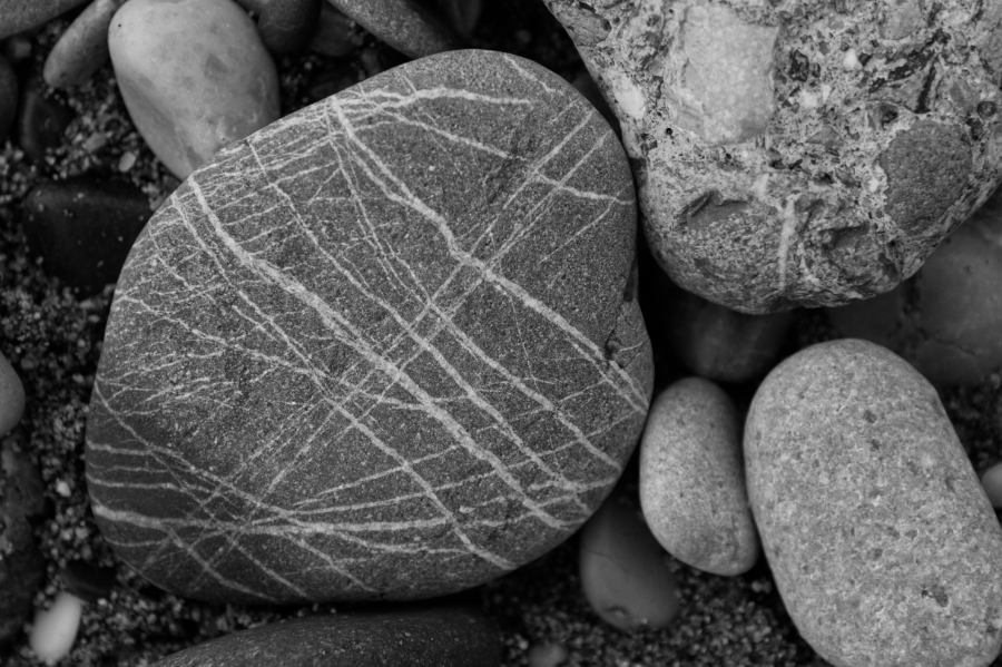 Pebbles on the beach in Plaka in black and white