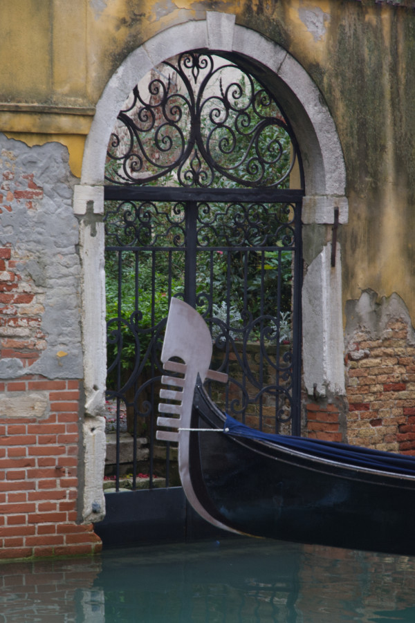 Gondola in narrow canal, in historic city centre Venice